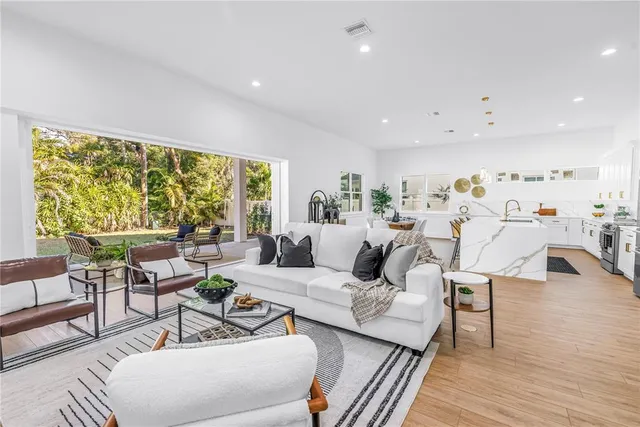 a living room with furniture and a large window
