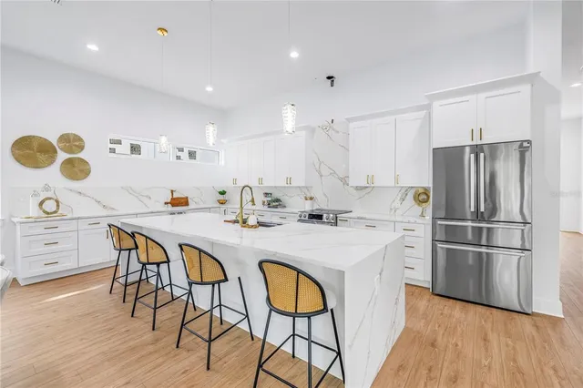 a kitchen with a table chairs refrigerator and microwave