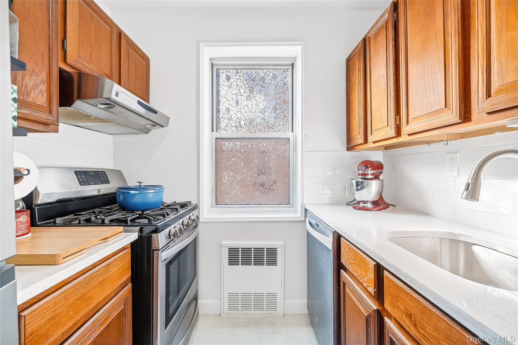 609 Palmer Road, Unit 5L Yonkers, NY 10701 - Photo 14 of 35 Kitchen with stainless steel appliances, tiled floor and subway tile backsplash.