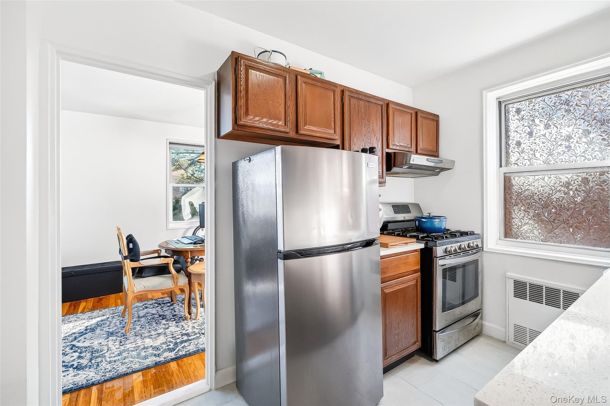 609 Palmer Road, Unit 5L Yonkers, NY 10701 - Photo 10 of 35 Kitchen with stainless steel appliances, tiled floor, quartz countertop and subway tile backsplash.