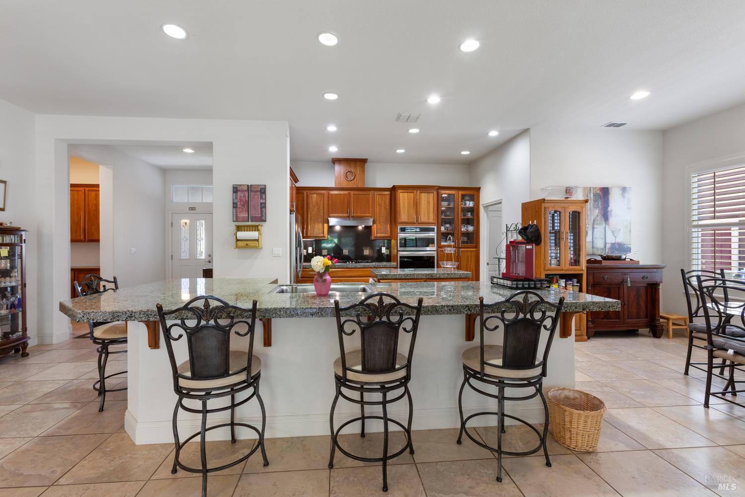 900 Livingston Place Rio Vista, CA 94571 - Photo 13 of 38 a kitchen with a dining table chairs stainless steel appliances and cabinets