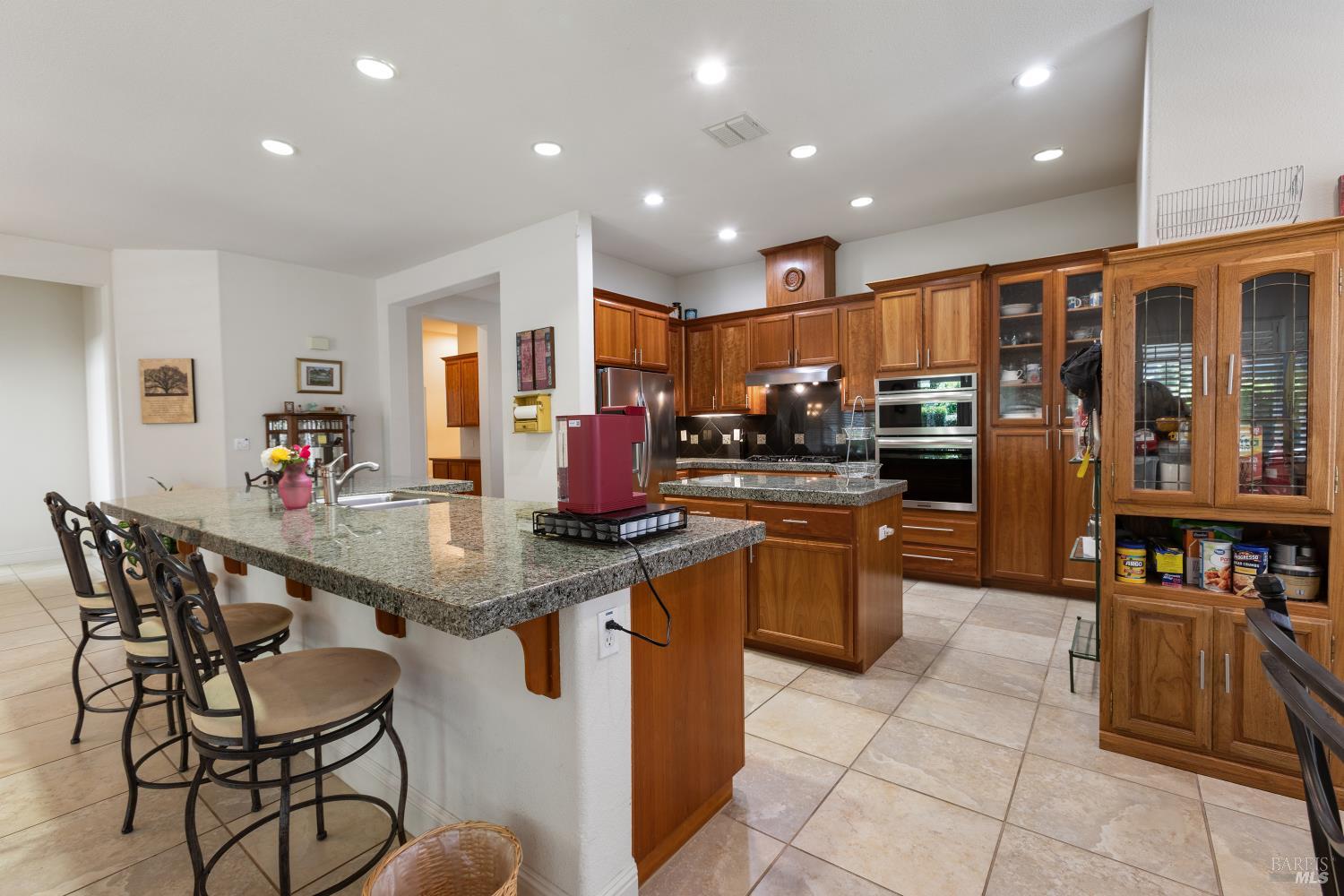 900 Livingston Place Rio Vista, CA 94571 - Photo 14 of 38 a kitchen with stainless steel appliances granite countertop a table chairs and a refrigerator