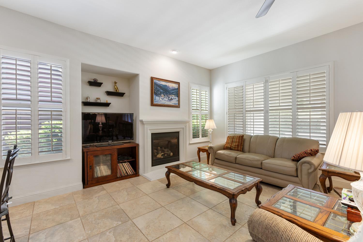 900 Livingston Place Rio Vista, CA 94571 - Photo 22 of 38 a living room with furniture a fireplace and a large window