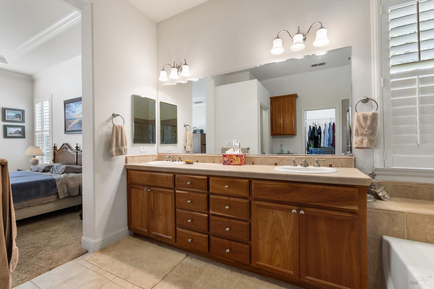 900 Livingston Place Rio Vista, CA 94571 - Photo 30 of 38 a spacious bathroom with a double vanity sink double and mirror