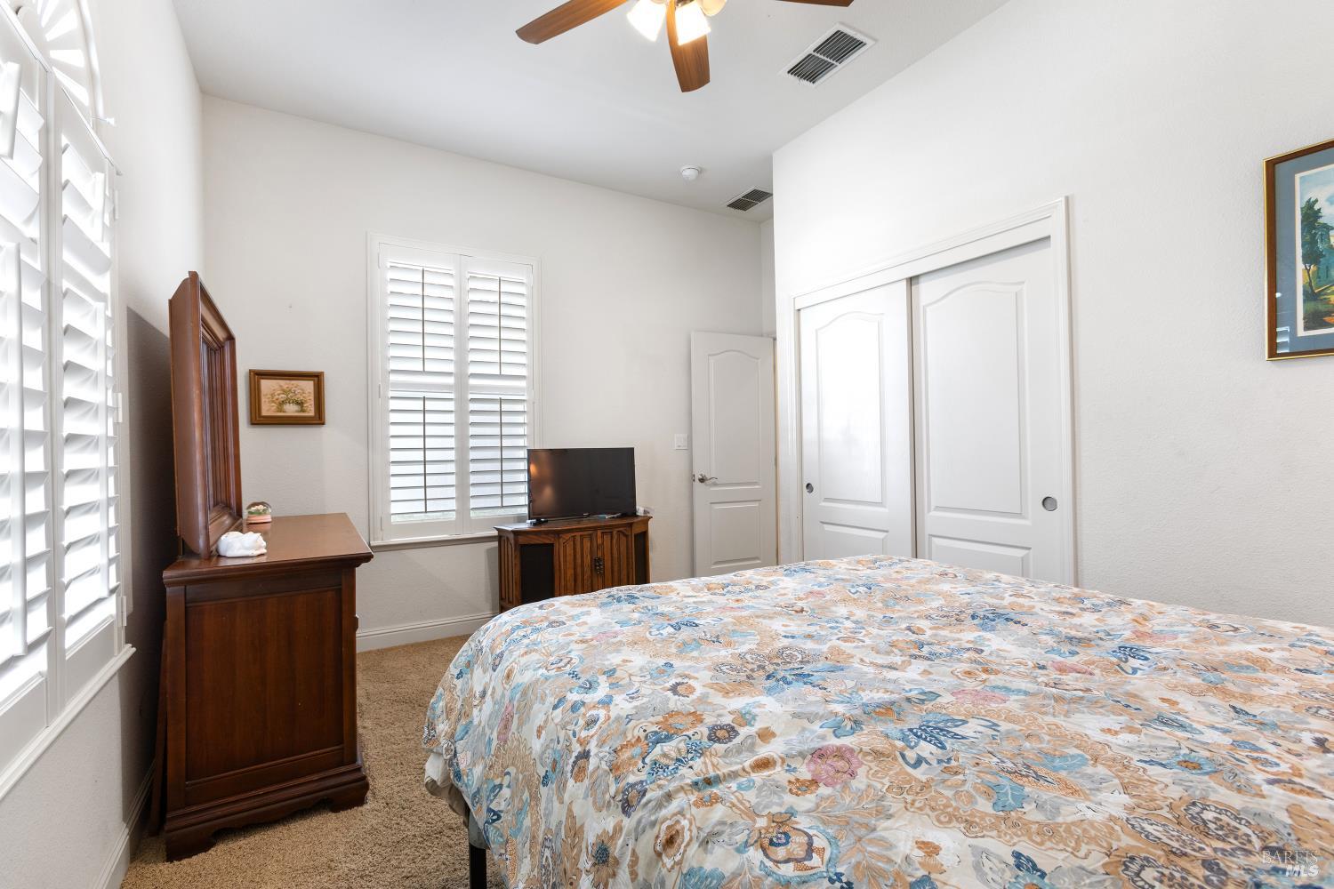 900 Livingston Place Rio Vista, CA 94571 - Photo 33 of 38 a bedroom with a bed and a chandelier