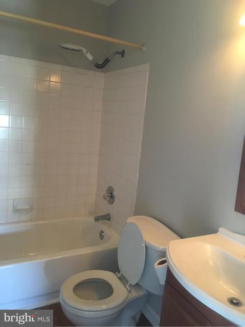 4401 Cole Farm Road Baltimore, MD 21236 - Photo 12 of 21 a white toilet and tub sitting next to a bathroom sink