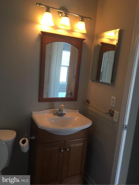 4401 Cole Farm Road Baltimore, MD 21236 - Photo 16 of 21 a bathroom with a sink and a mirror
