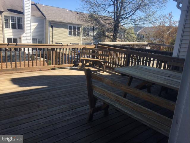 4401 Cole Farm Road Baltimore, MD 21236 - Photo 18 of 21 a view of a wooden deck with a bench