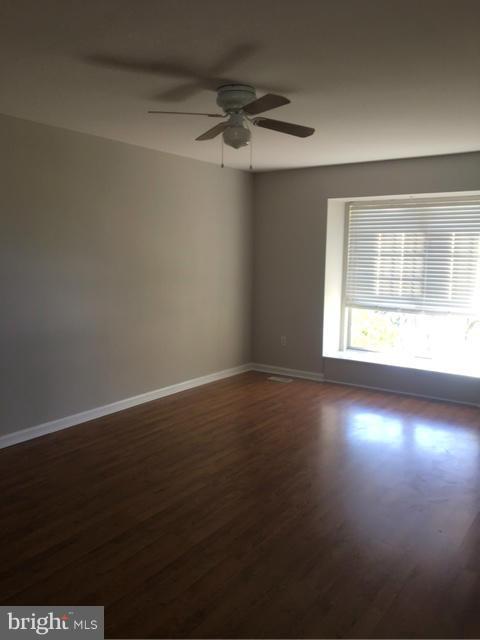 4401 Cole Farm Road Baltimore, MD 21236 - Photo 4 of 21 a view of an empty room with wooden floor and a window