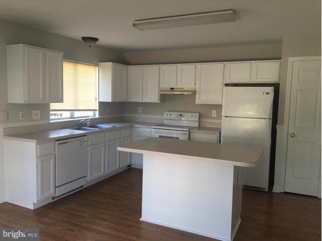 4401 Cole Farm Road Baltimore, MD 21236 - Photo 5 of 21 a kitchen with kitchen island a sink stainless steel appliances and white cabinets