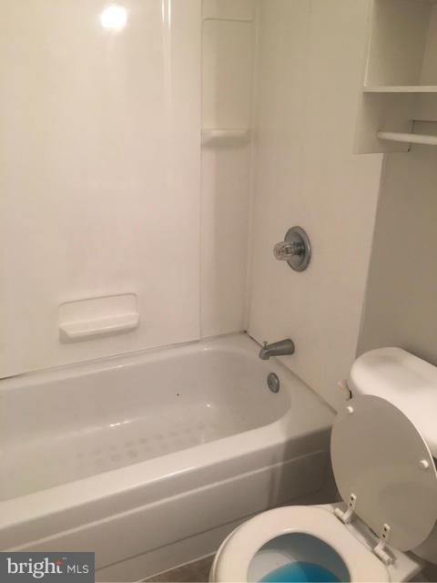 4401 Cole Farm Road Baltimore, MD 21236 - Photo 8 of 21 a bathroom with a toilet and a bathtub