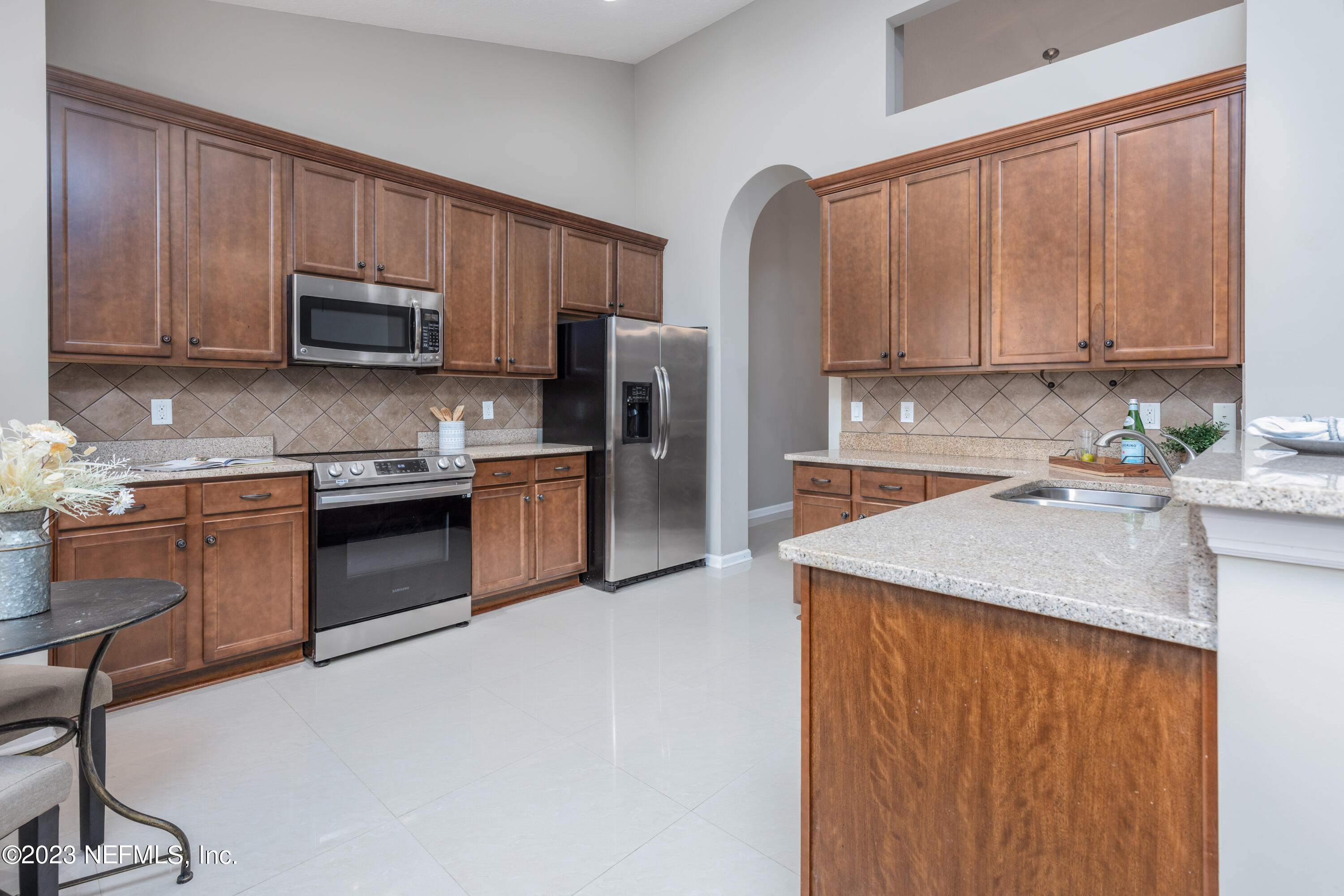 1516 Valhalla Way St. Augustine, FL 32092 - Photo 15 of 46 a kitchen with stainless steel appliances granite countertop a stove a sink dishwasher and a refrigerator