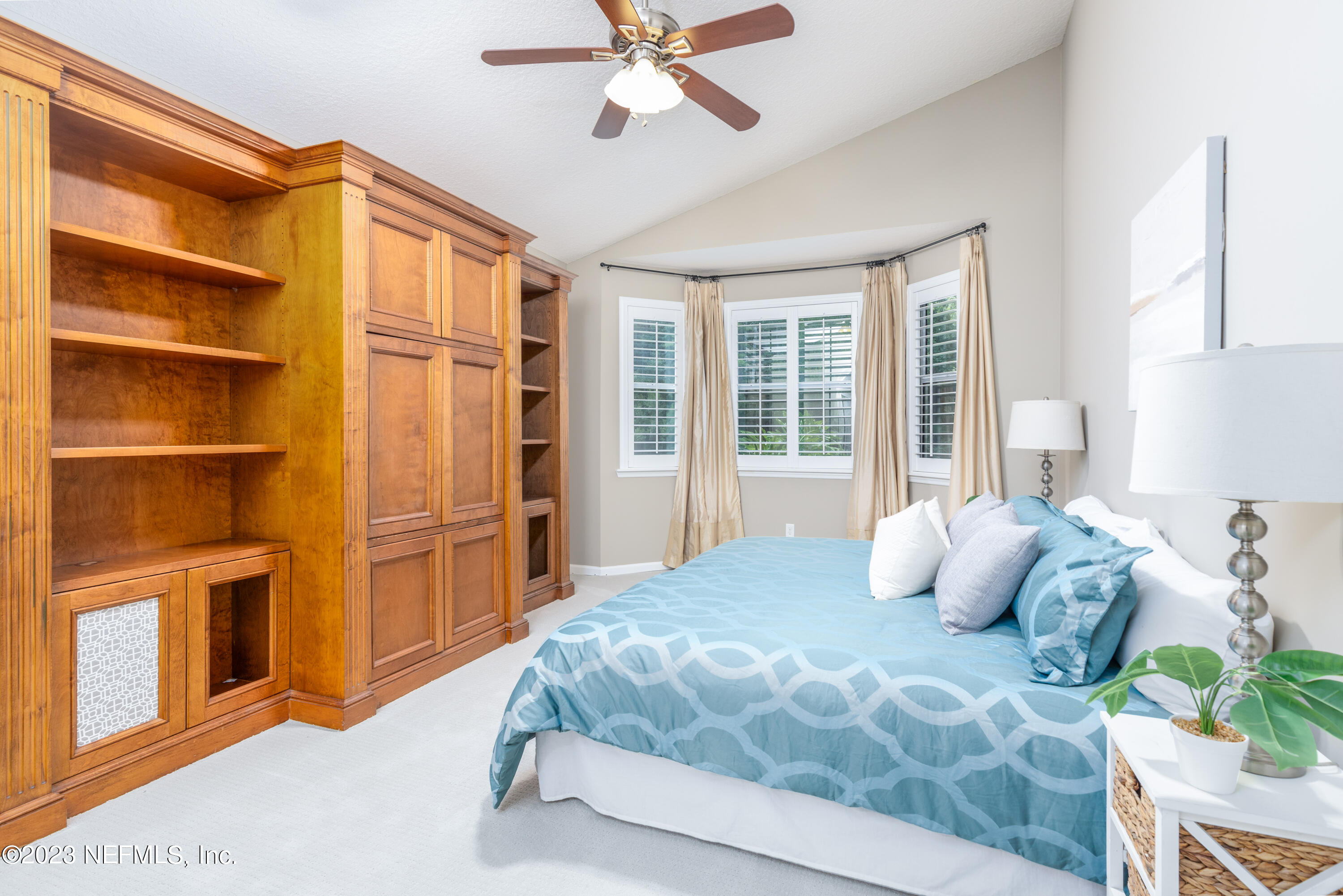 1516 Valhalla Way St. Augustine, FL 32092 - Photo 20 of 46 a bedroom with a bed cabinets and a window