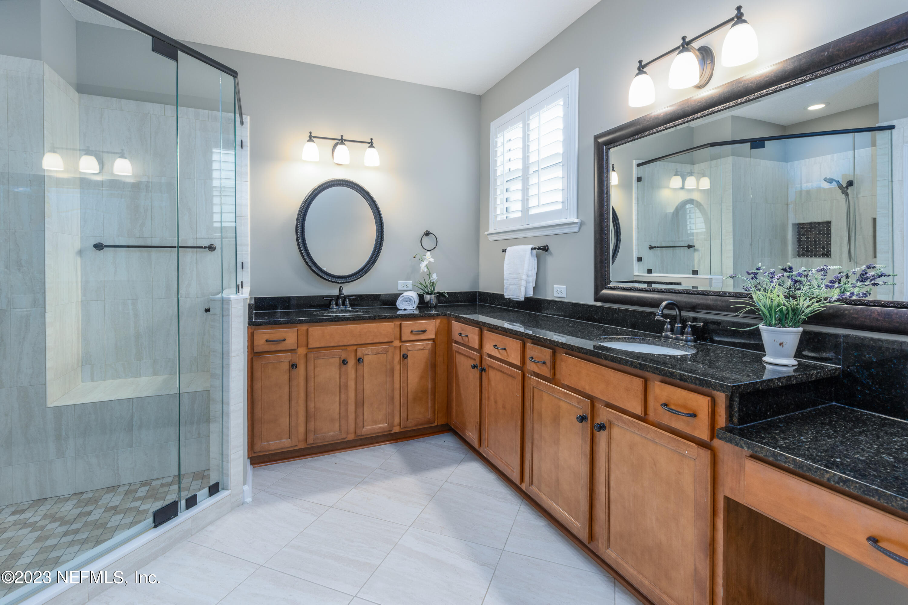 1516 Valhalla Way St. Augustine, FL 32092 - Photo 21 of 46 a bathroom with a double vanity sink mirror and a shower