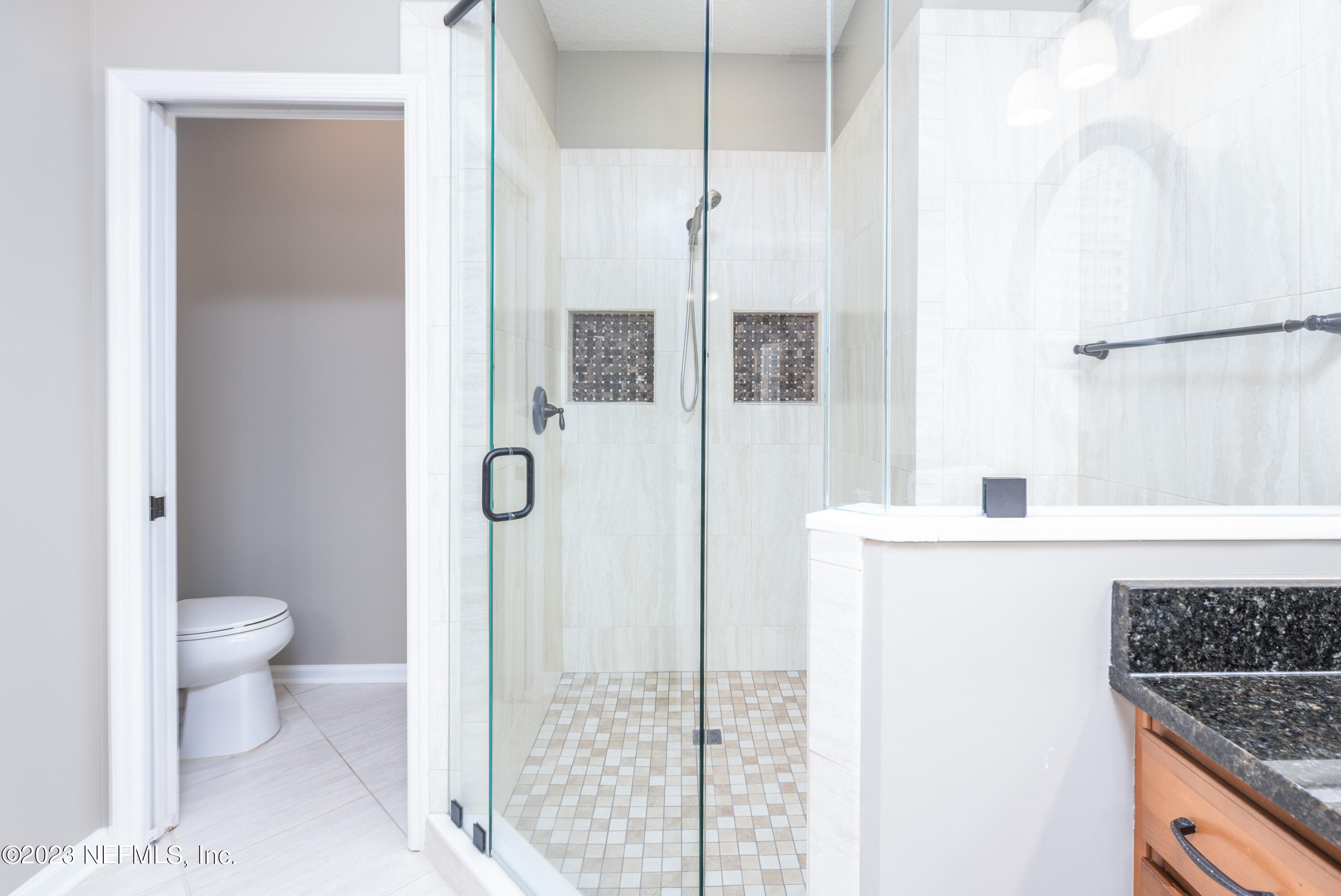 1516 Valhalla Way St. Augustine, FL 32092 - Photo 22 of 46 a bathroom with a granite countertop sink toilet and shower