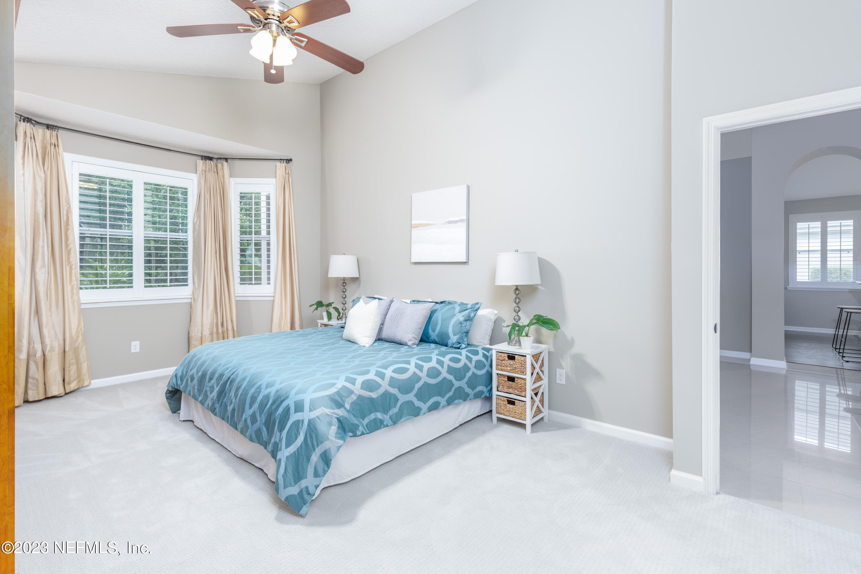 1516 Valhalla Way St. Augustine, FL 32092 - Photo 5 of 46 a bedroom with a large bed and a chandelier