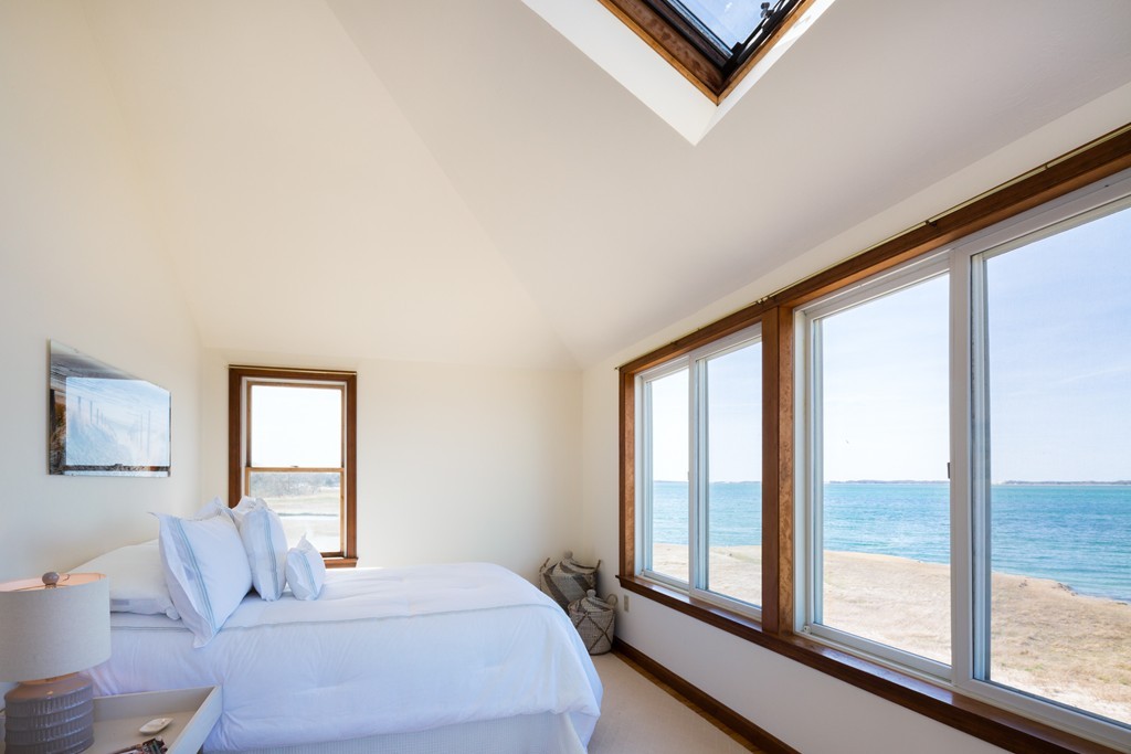 87 Salten Point Road Barnstable, MA 02630 - Photo 15 of 27 a bedroom with a large bed and a large window