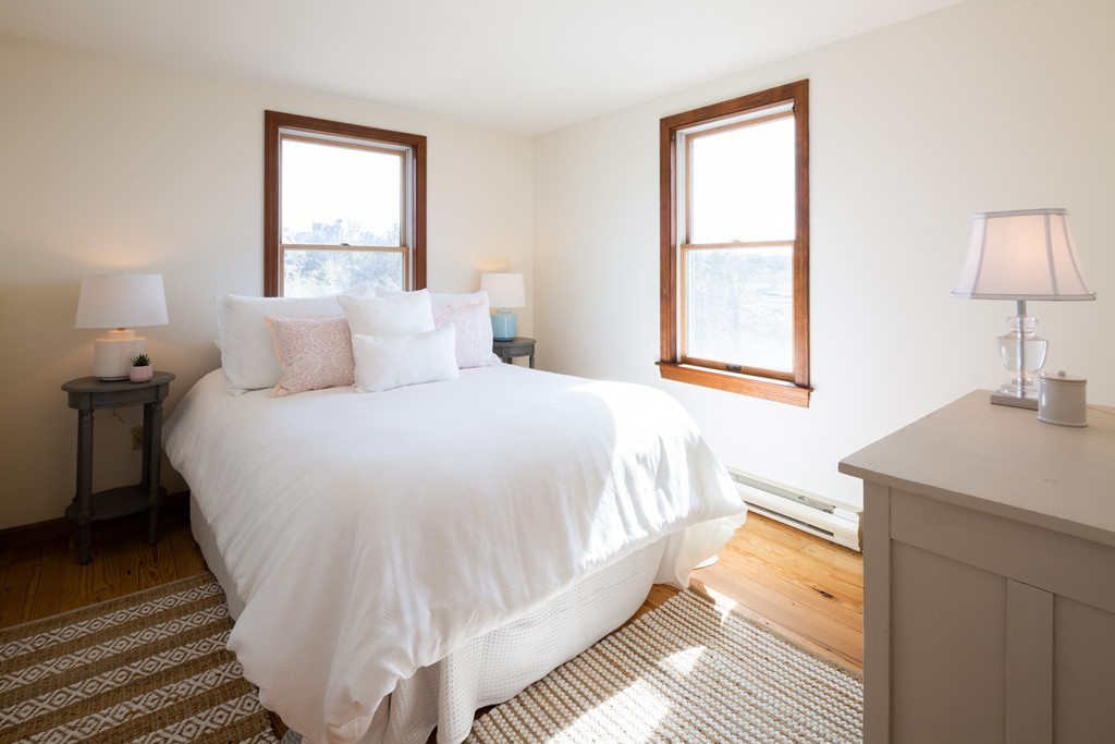 87 Salten Point Road Barnstable, MA 02630 - Photo 19 of 27 a bedroom with a bed and a table lamp