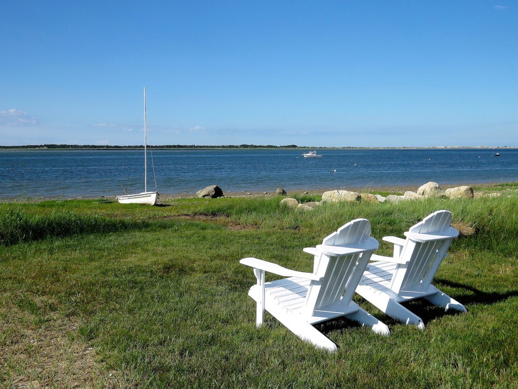 87 Salten Point Road Barnstable, MA 02630 - Photo 3 of 27 a view of a lake with lawn chairs