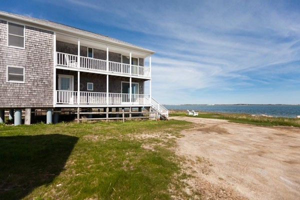 87 Salten Point Road Barnstable, MA 02630 - Photo 5 of 27 a view of a swimming pool with an outdoor space and seating area