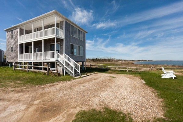 87 Salten Point Road Barnstable, MA 02630 - Photo 6 of 27 a view of an ocean with a house in the background