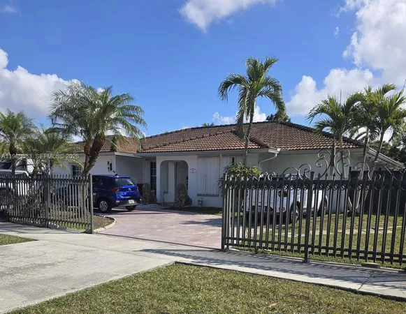 a view of a house with a yard and plants