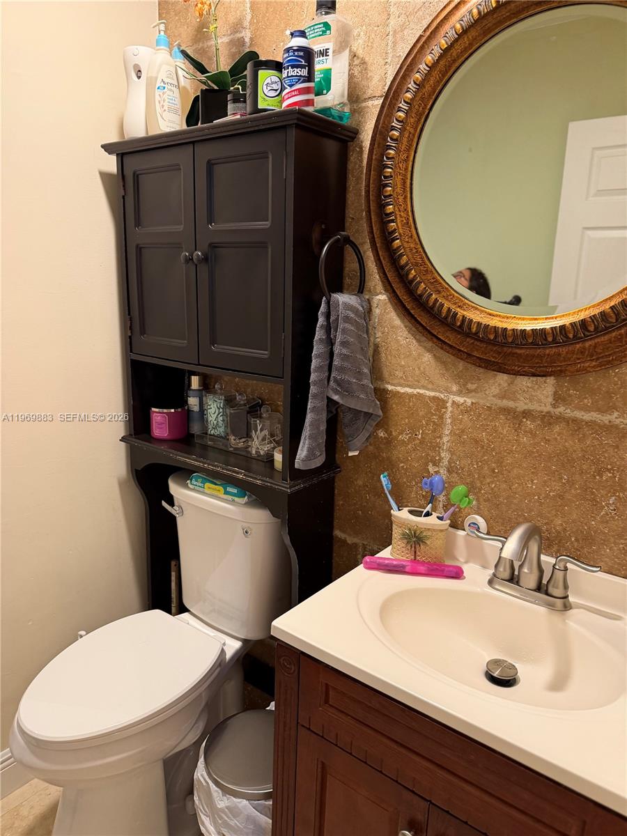 15641 Southwest 147th Avenue Miami, FL 33187 - Photo 11 of 20 a bathroom with a sink a toilet and a mirror