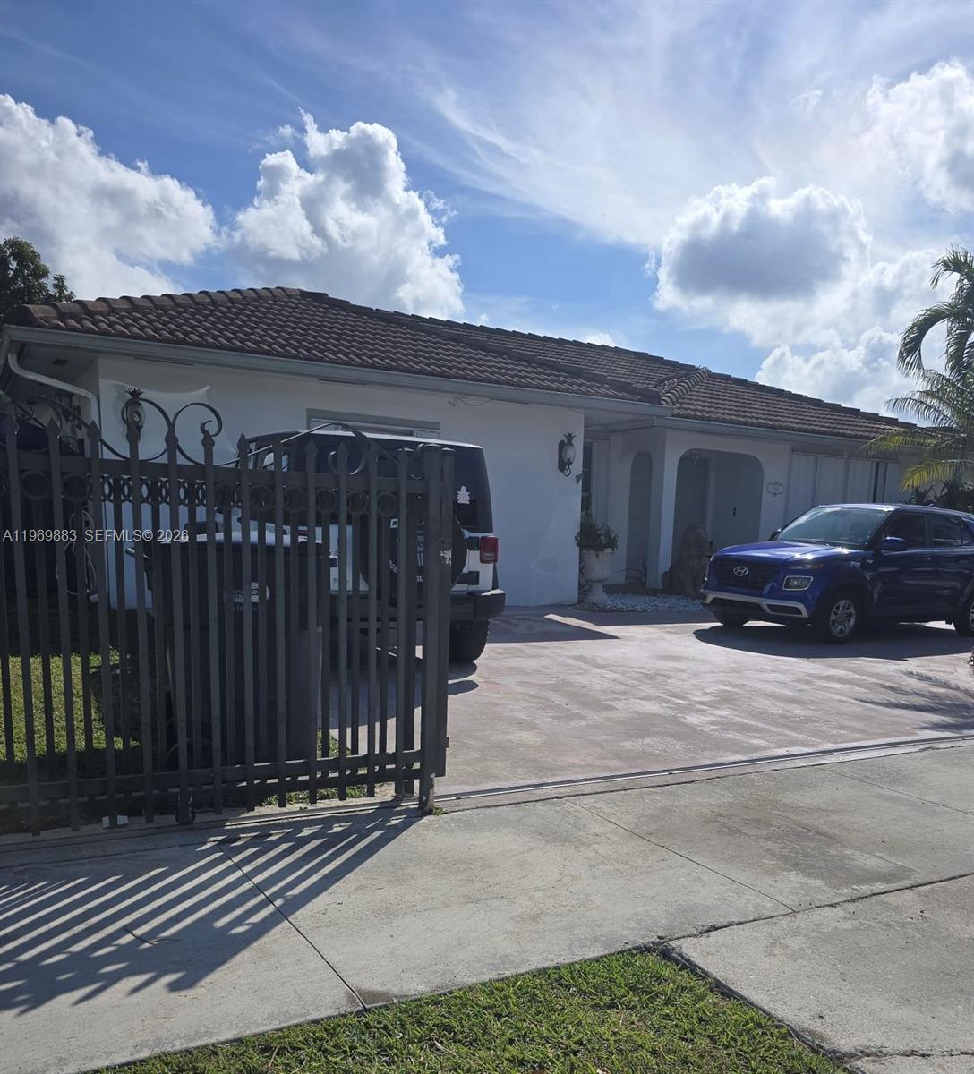 15641 Southwest 147th Avenue Miami, FL 33187 - Photo 15 of 20 a front view of a house with a yard and garage
