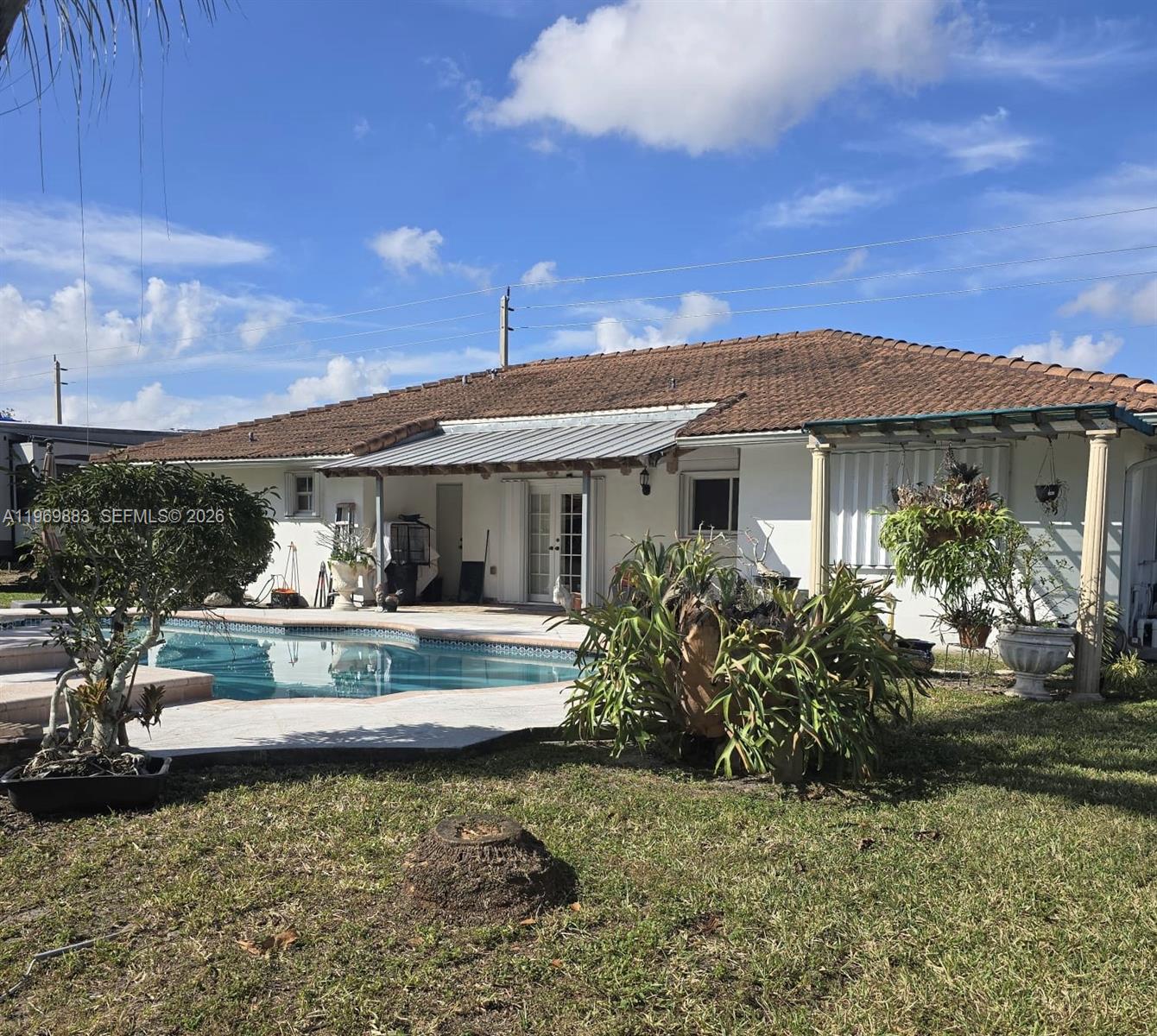 15641 Southwest 147th Avenue Miami, FL 33187 - Photo 17 of 20 a view of a house with swimming pool and sitting area