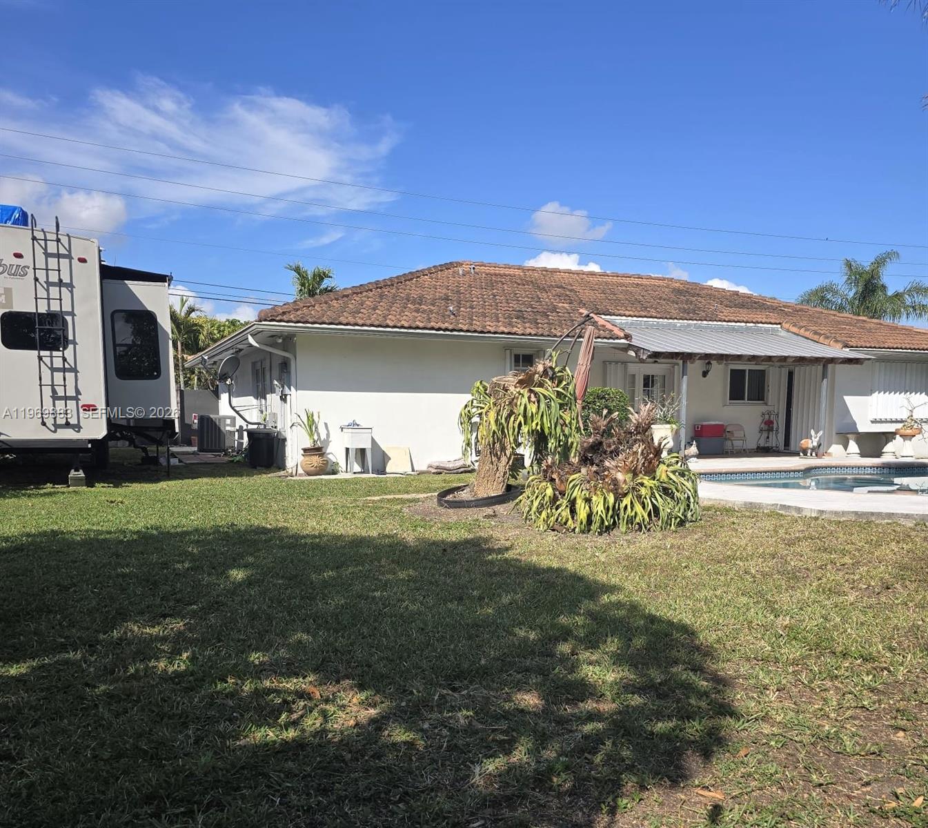 15641 Southwest 147th Avenue Miami, FL 33187 - Photo 18 of 20 a front view of a house with garden
