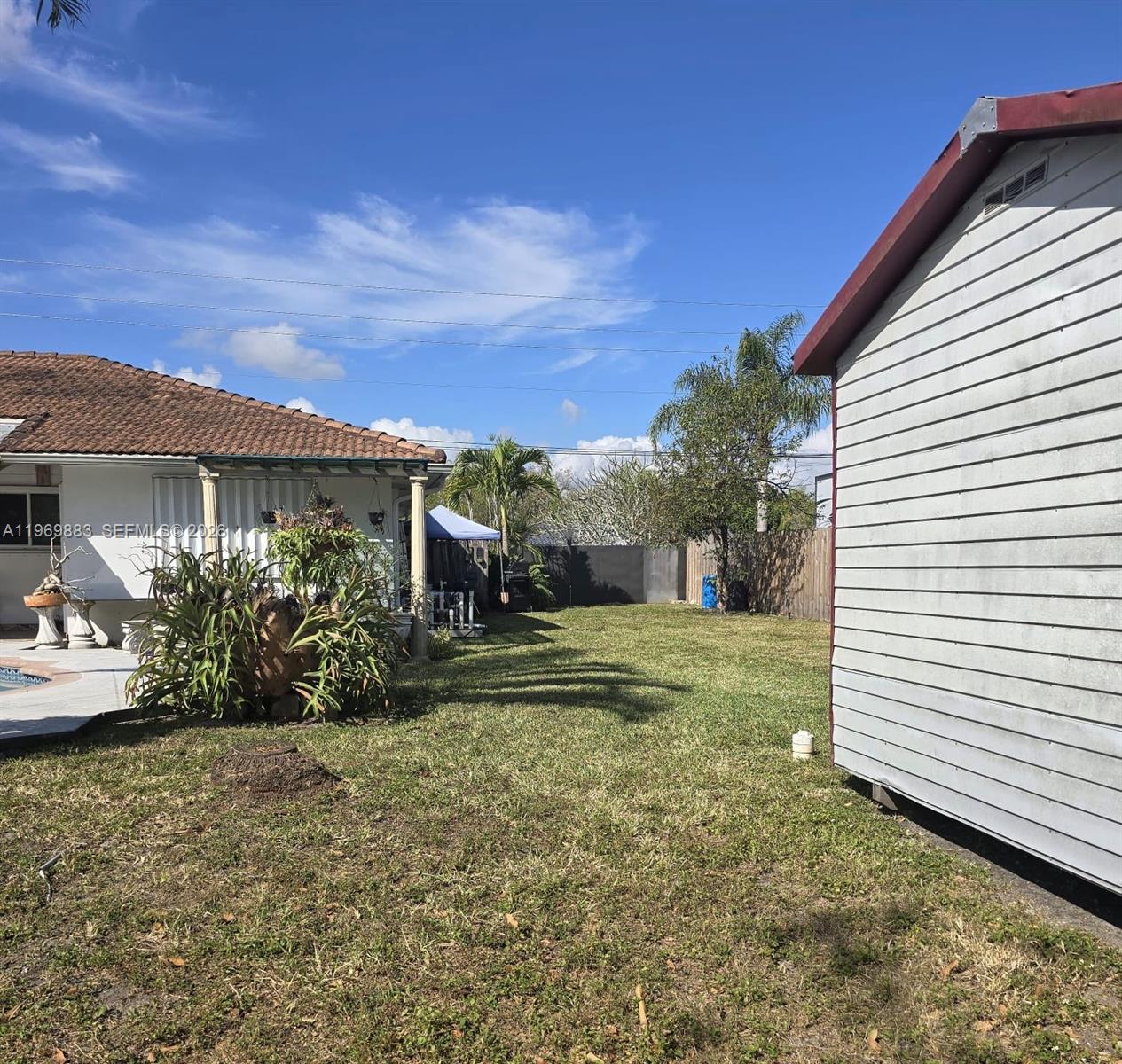15641 Southwest 147th Avenue Miami, FL 33187 - Photo 19 of 20 a view of a house with a yard