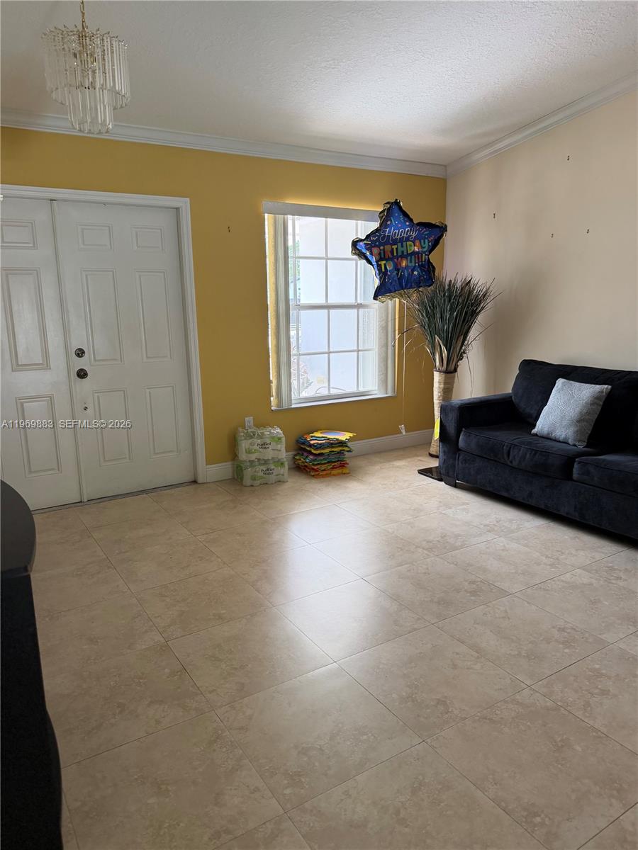 15641 Southwest 147th Avenue Miami, FL 33187 - Photo 4 of 20 a living room with furniture and a large window
