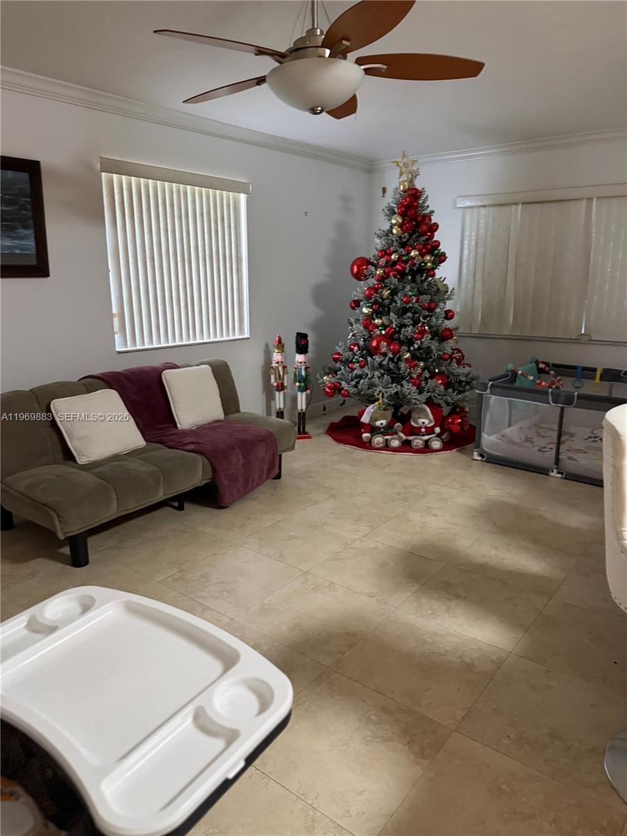 15641 Southwest 147th Avenue Miami, FL 33187 - Photo 6 of 20 a living room with furniture and a potted plant