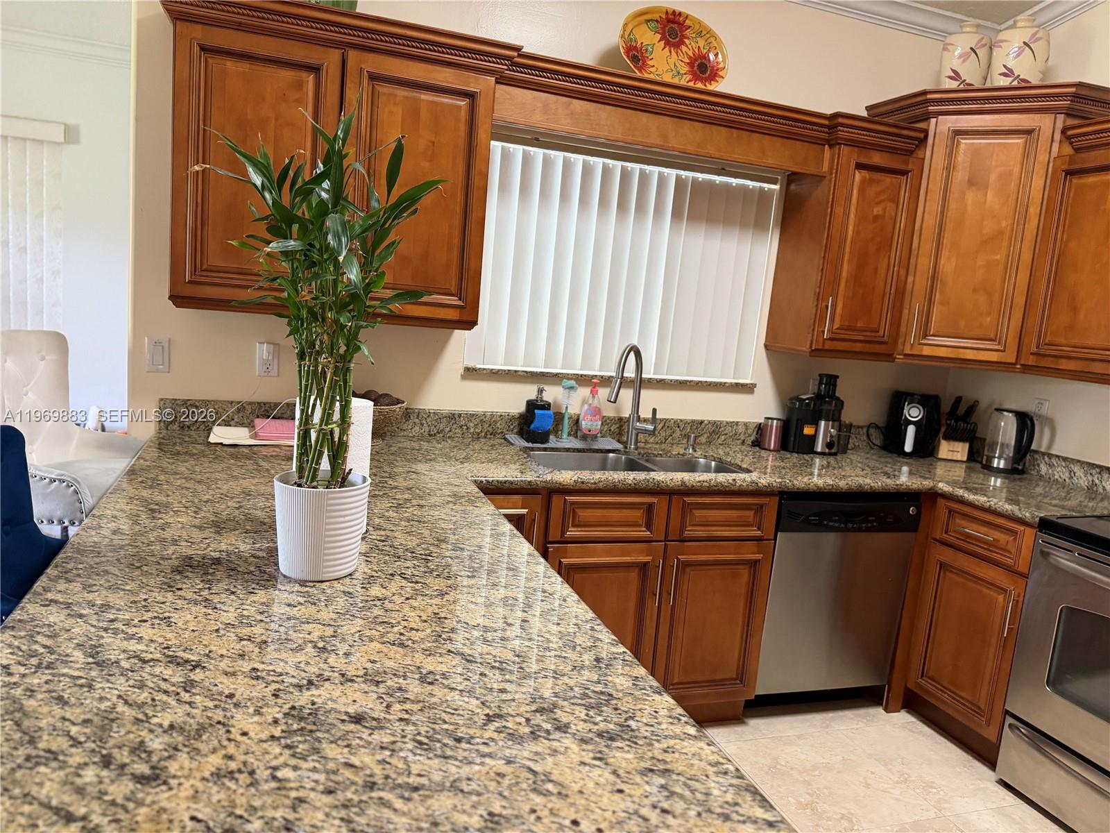15641 Southwest 147th Avenue Miami, FL 33187 - Photo 9 of 20 a kitchen with a refrigerator and a sink