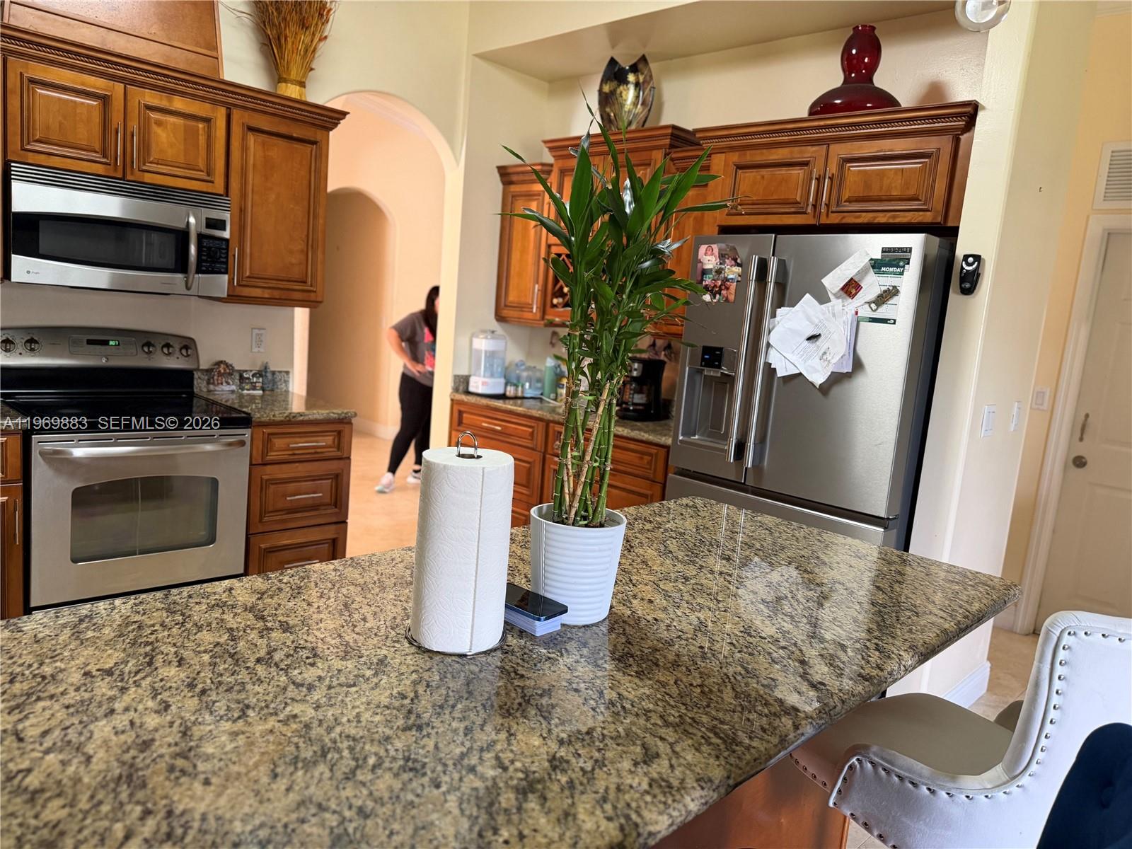15641 Southwest 147th Avenue Miami, FL 33187 - Photo 10 of 20 a kitchen with a stove a refrigerator and cabinets