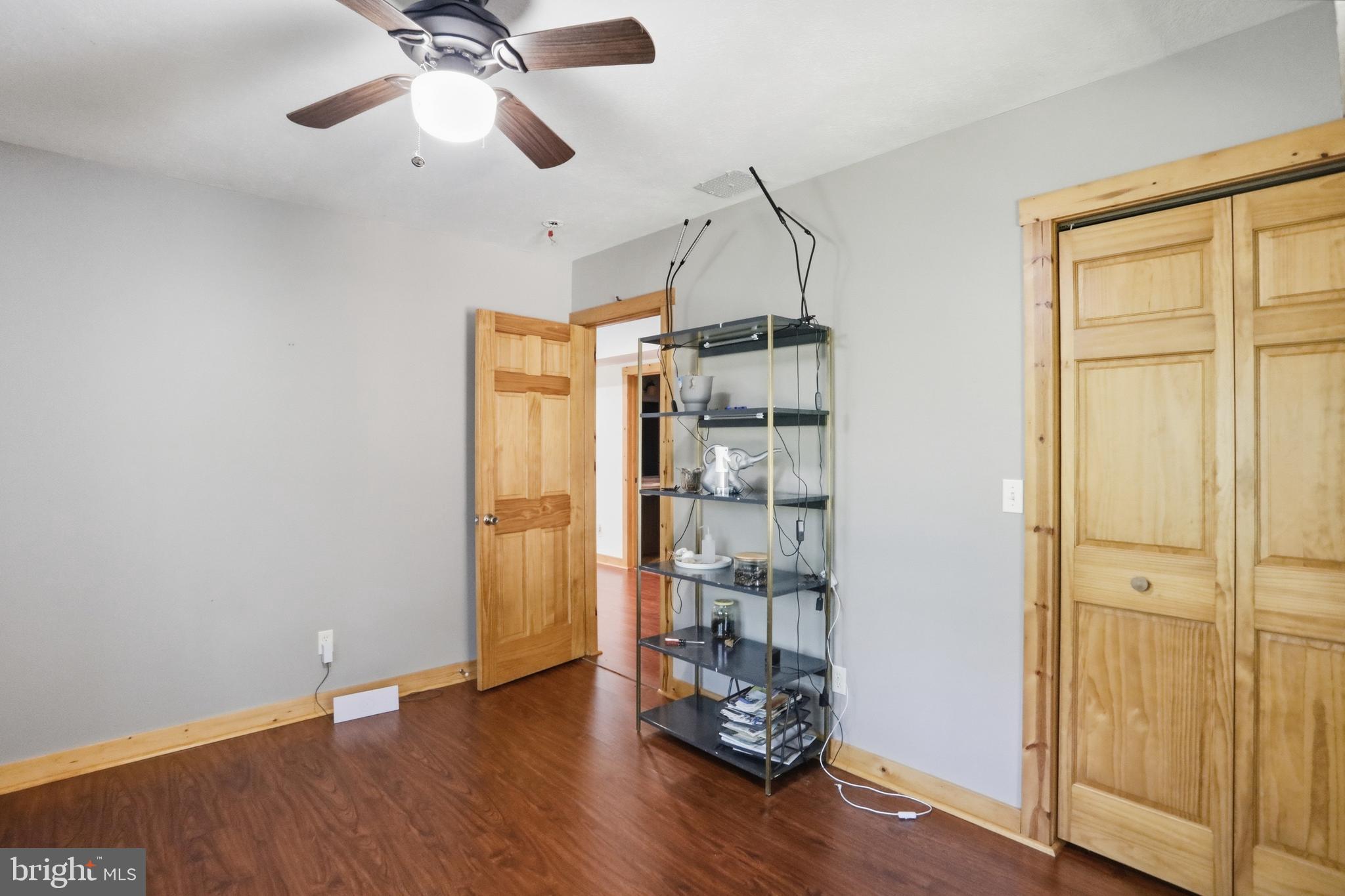 1400 Core Road Romney, WV 26757 - Photo 37 of 73 a view of empty room with wooden floor and fan
