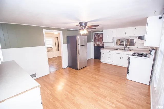 a kitchen with stainless steel appliances a refrigerator and a stove