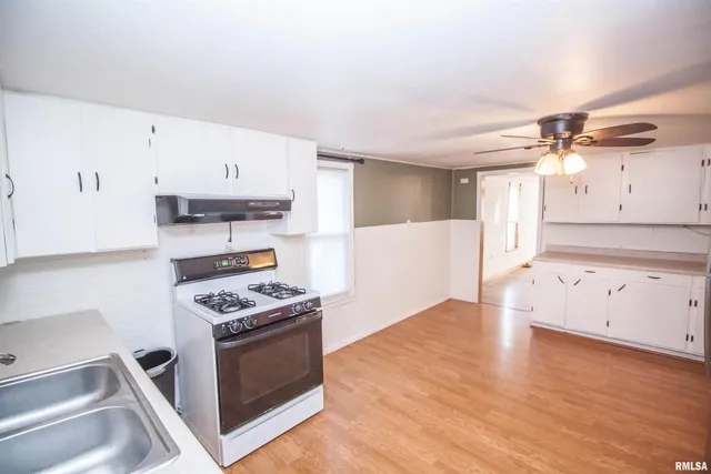 a kitchen with stainless steel appliances a stove a sink and a refrigerator