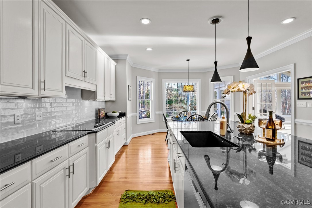 14337 Riverdowns S Drive Midlothian, VA 23113 - Photo 12 of 44 a kitchen with stainless steel appliances kitchen island granite countertop a stove a sink a dining table and chairs with wooden floor