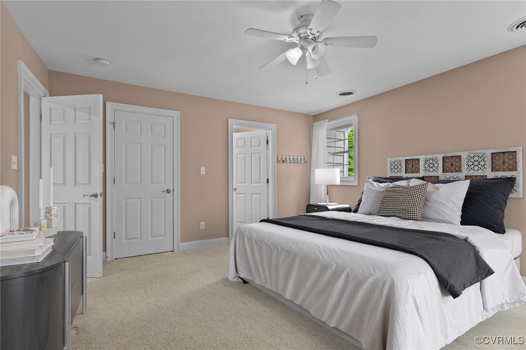 14337 Riverdowns S Drive Midlothian, VA 23113 - Photo 27 of 44 a spacious bedroom with a bed and a chandelier