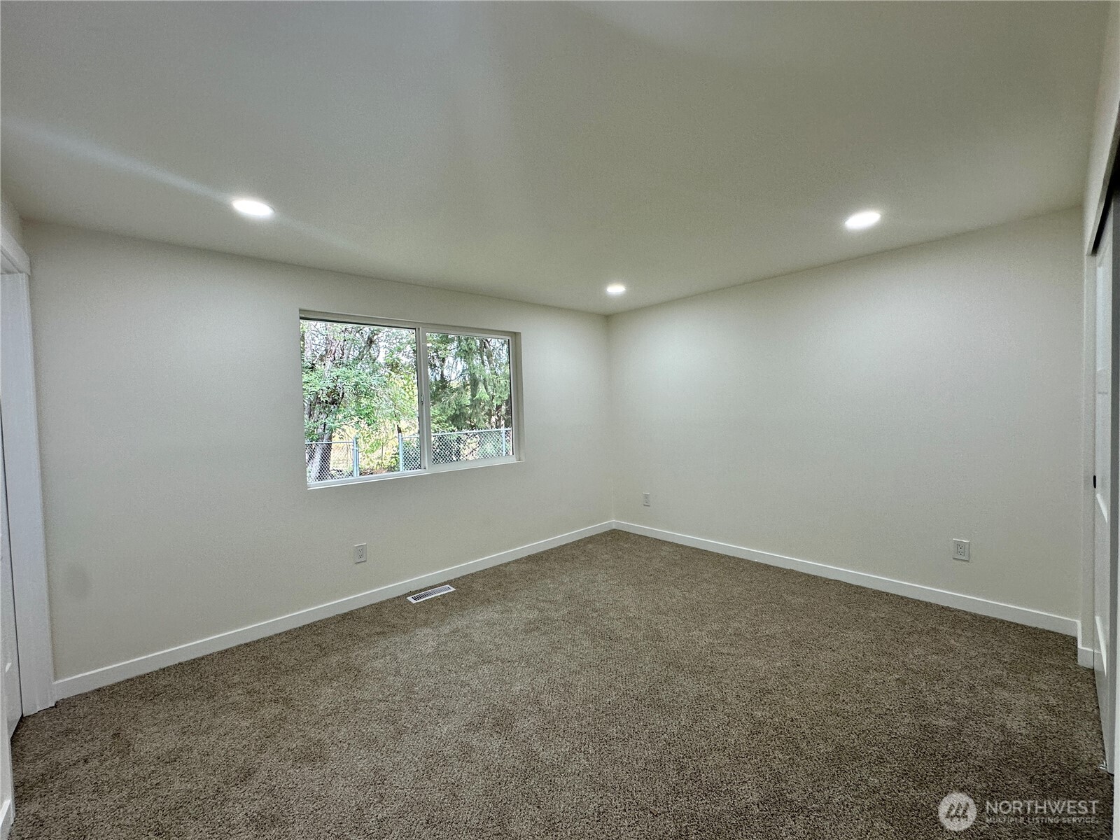 7044 Johnson Point Road Northeast Olympia, WA 98516 - Photo 17 of 36 an empty room with a window