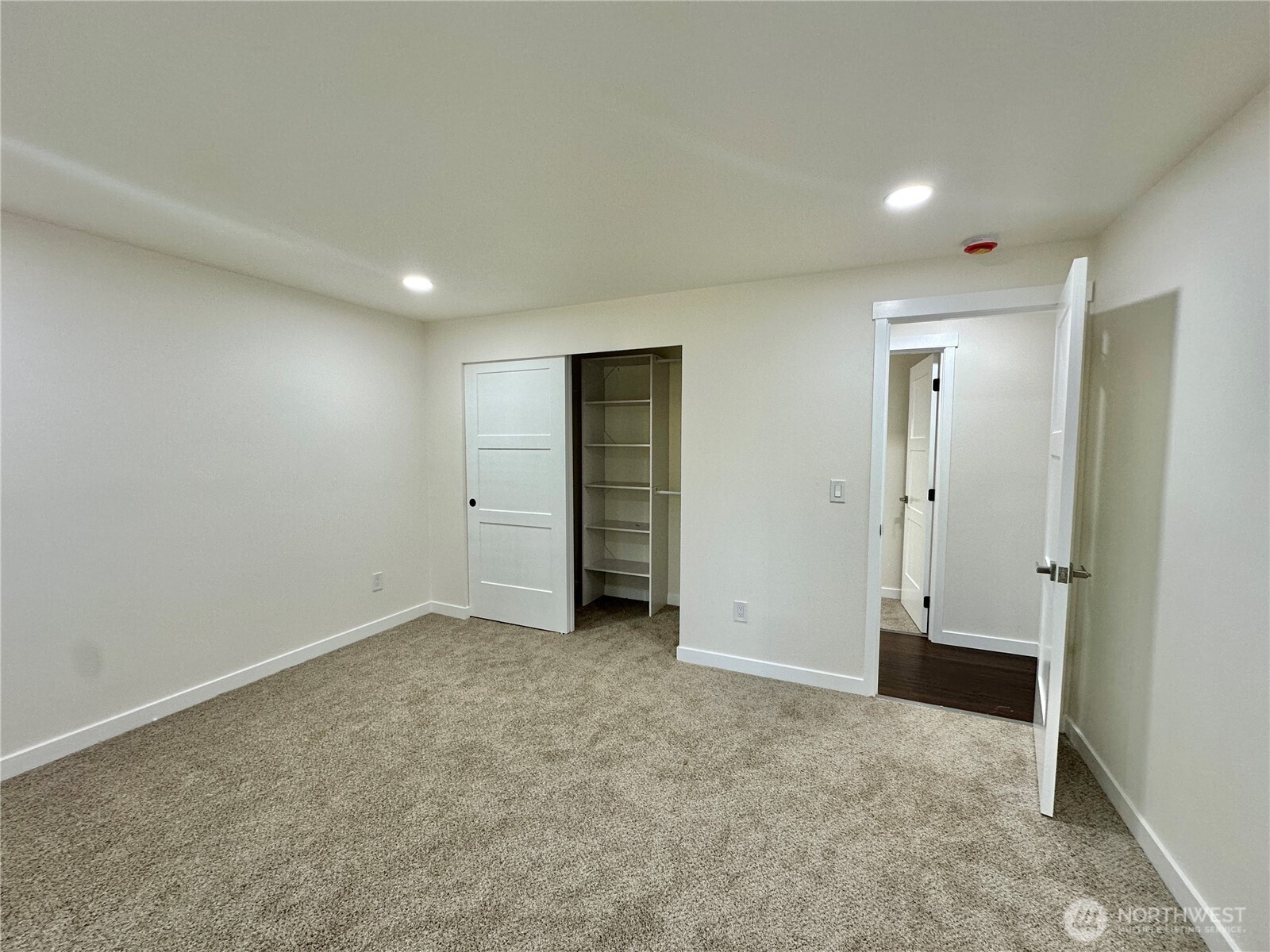 7044 Johnson Point Road Northeast Olympia, WA 98516 - Photo 18 of 36 an empty room with closet and mirror