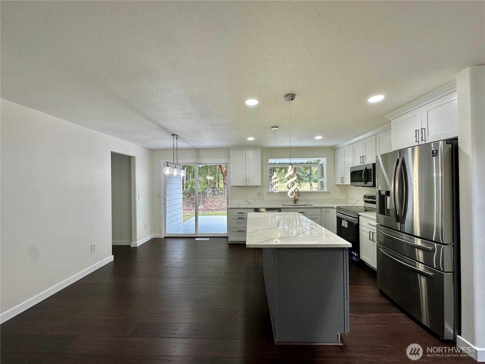 7044 Johnson Point Road Northeast Olympia, WA 98516 - Photo 5 of 36 a large kitchen with a large window and stainless steel appliances
