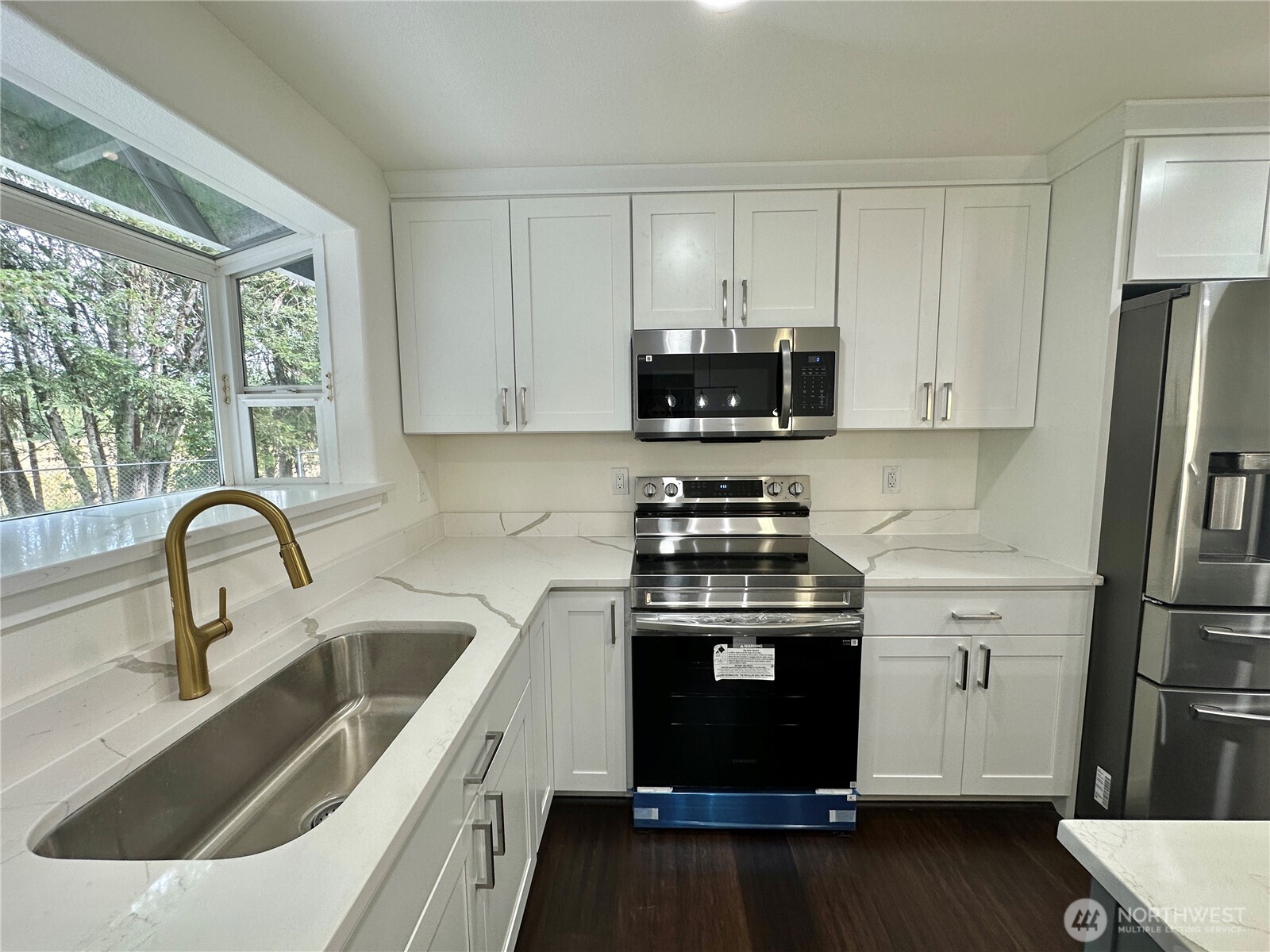7044 Johnson Point Road Northeast Olympia, WA 98516 - Photo 7 of 36 a kitchen with a sink stove and refrigerator