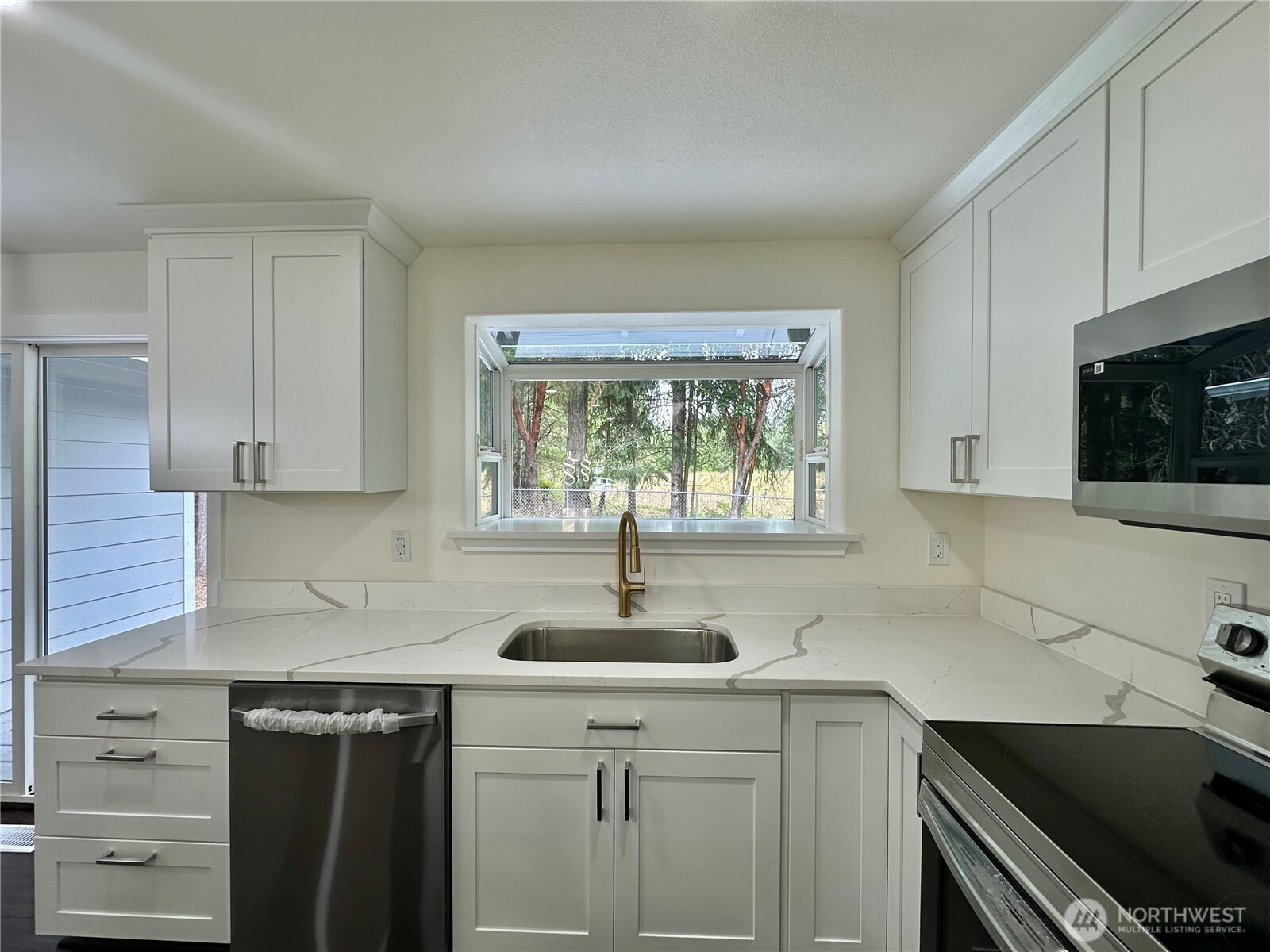 7044 Johnson Point Road Northeast Olympia, WA 98516 - Photo 8 of 36 a kitchen with a sink stove and cabinets