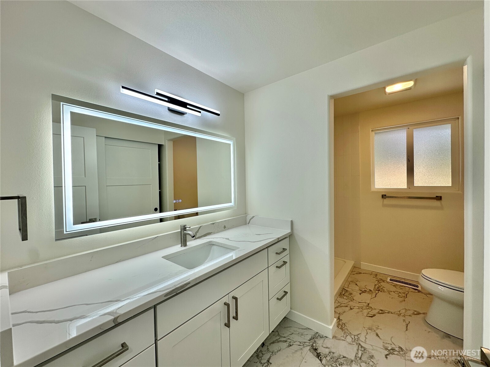 7044 Johnson Point Road Northeast Olympia, WA 98516 - Photo 9 of 36 a bathroom with a sink and a mirror