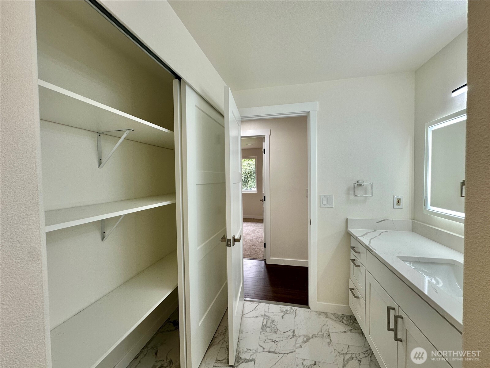 7044 Johnson Point Road Northeast Olympia, WA 98516 - Photo 10 of 36 a spacious bathroom with a granite countertop sink and a mirror