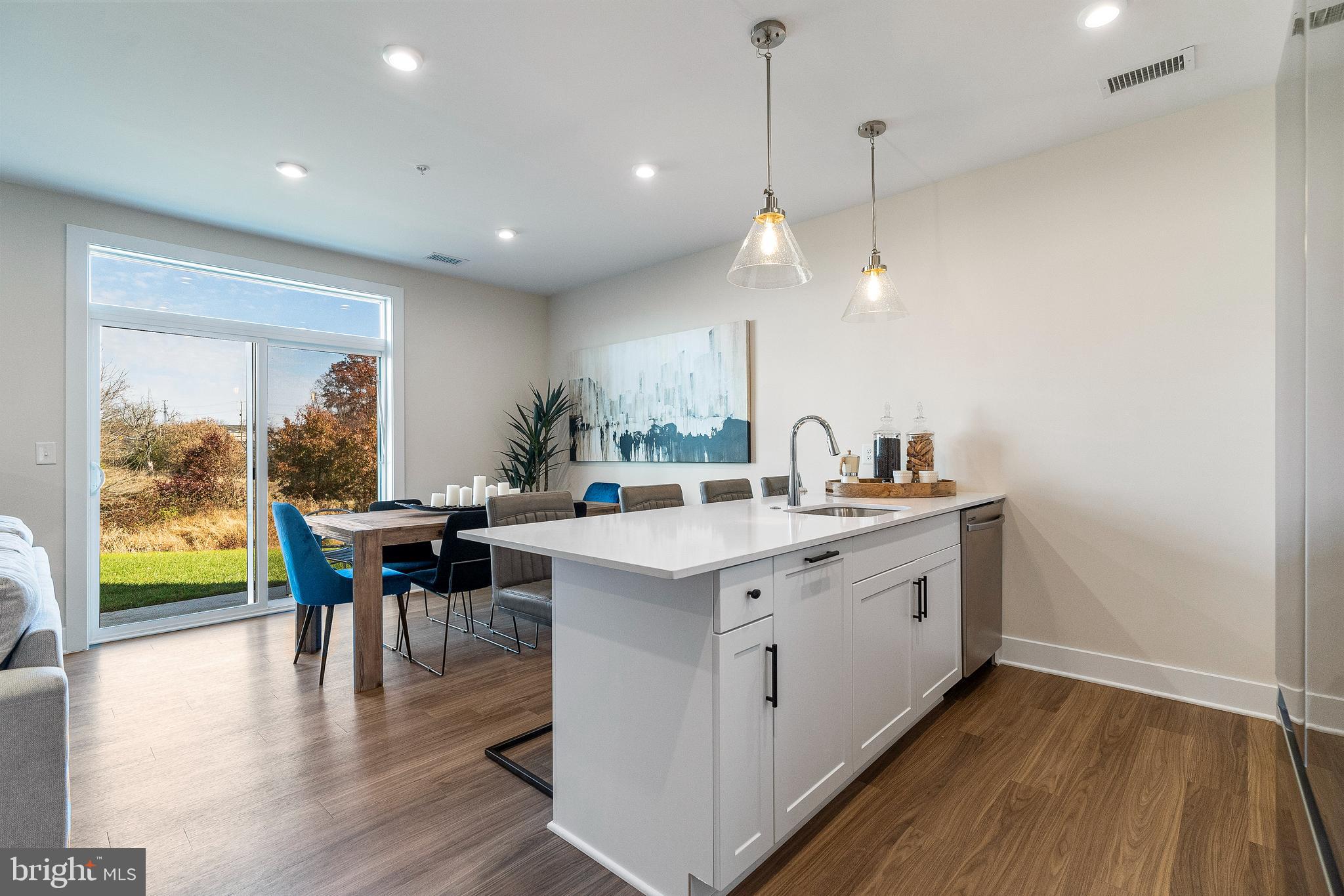 7 Mainland Road, Unit 102 Harleysville, PA 19438 - Photo 13 of 30 a kitchen with a table chairs and wooden floor