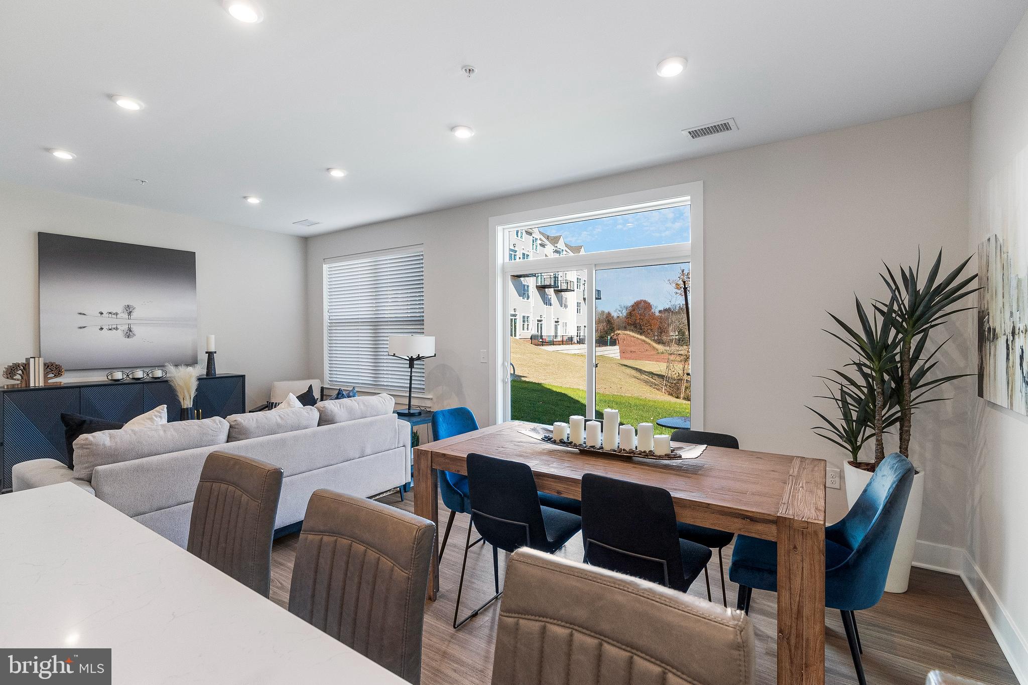 7 Mainland Road, Unit 102 Harleysville, PA 19438 - Photo 15 of 30 a living room with furniture a large window and a dining table