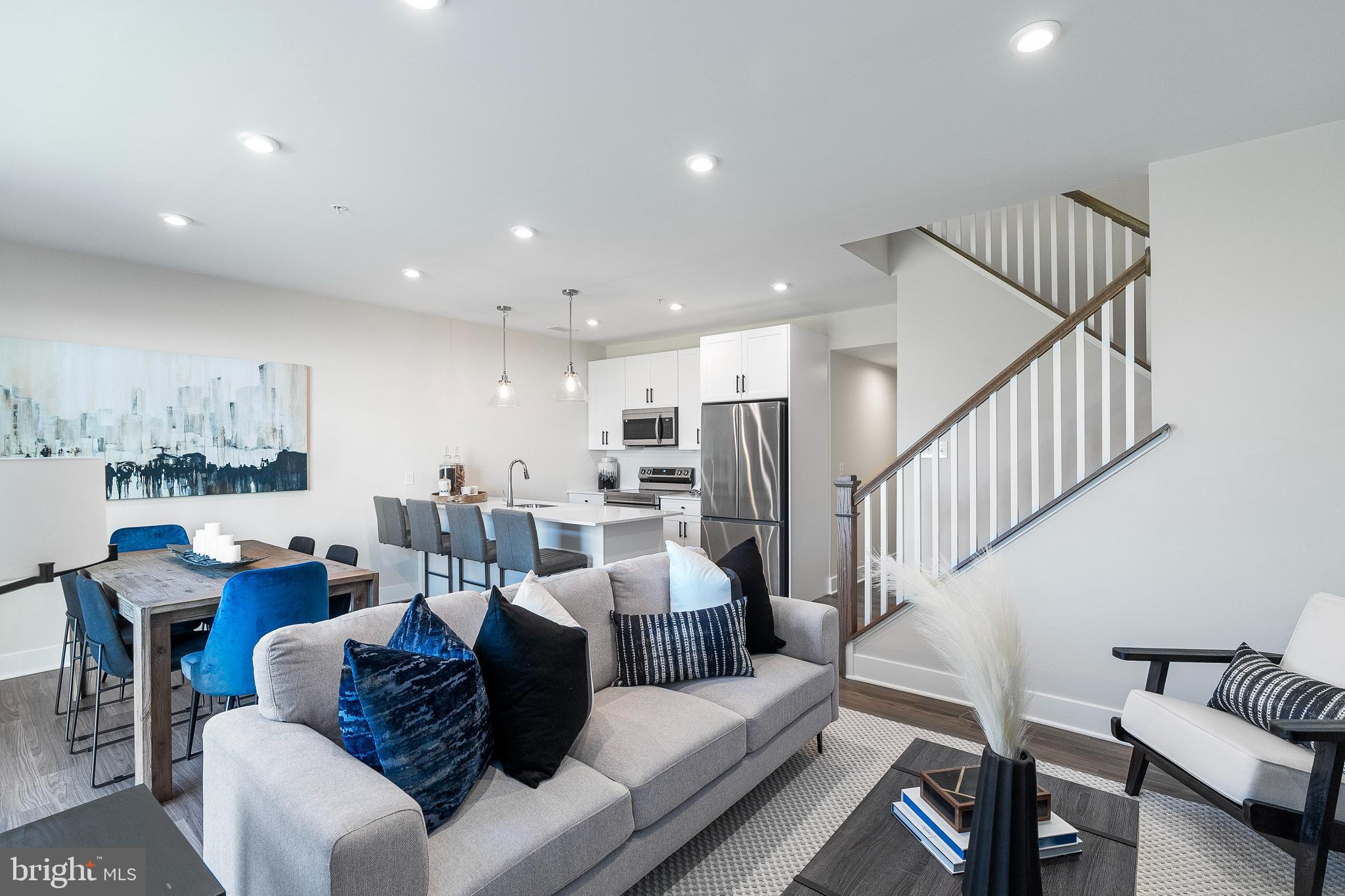 7 Mainland Road, Unit 102 Harleysville, PA 19438 - Photo 21 of 30 a living room with furniture kitchen view and a wooden floor
